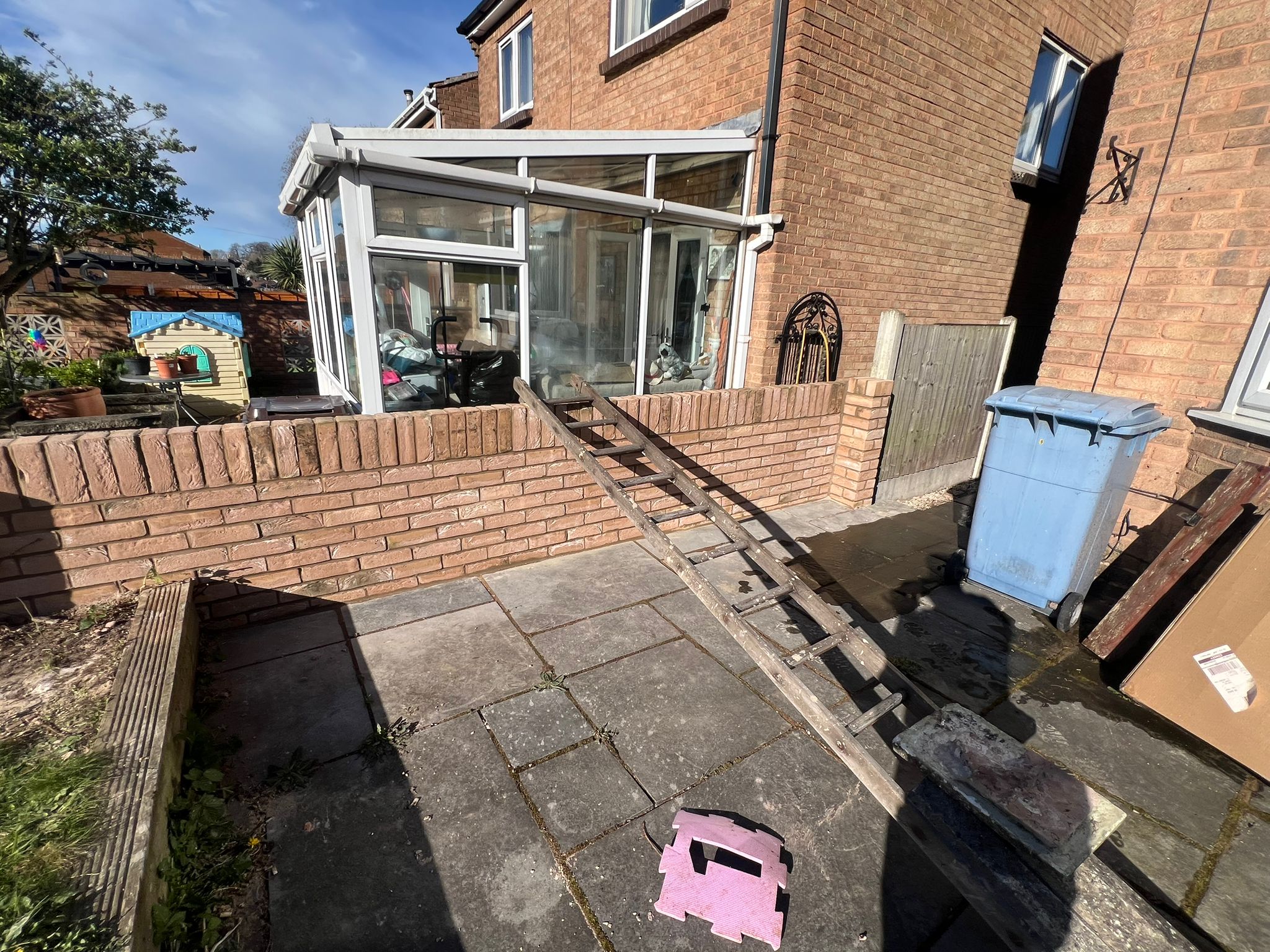 Wider rear view of completed external wall and patio area